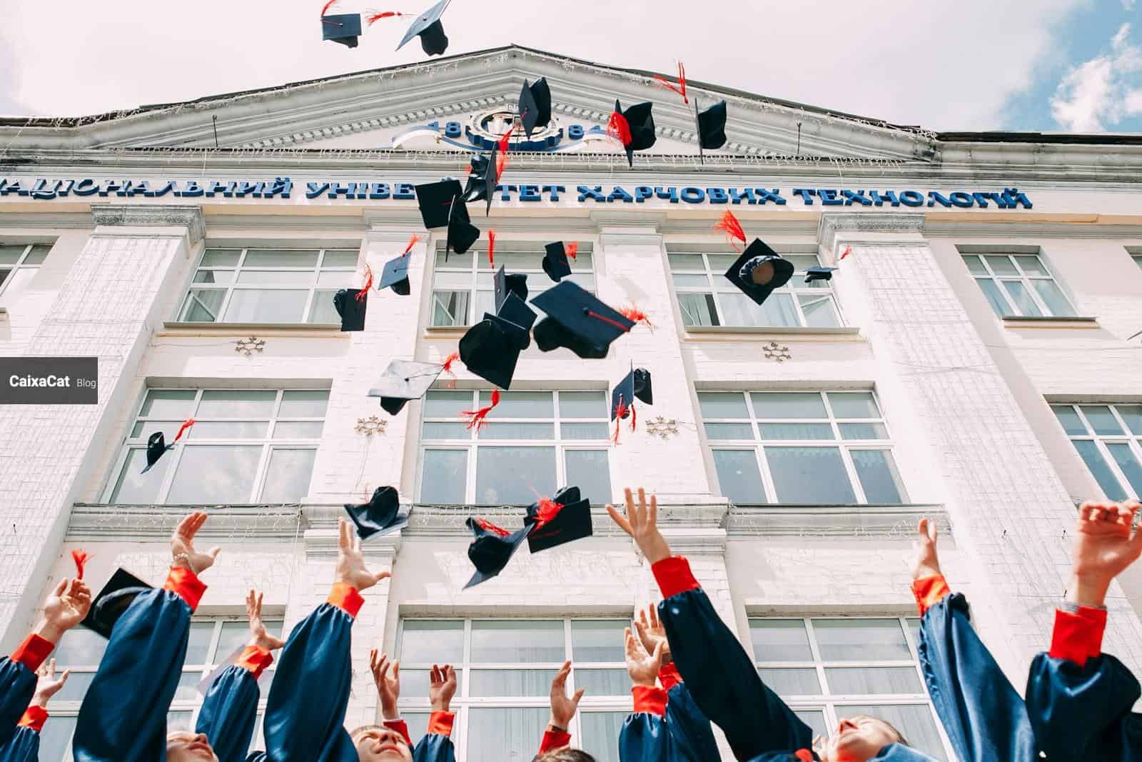 group of fresh graduates students throwing their academic hat in the air